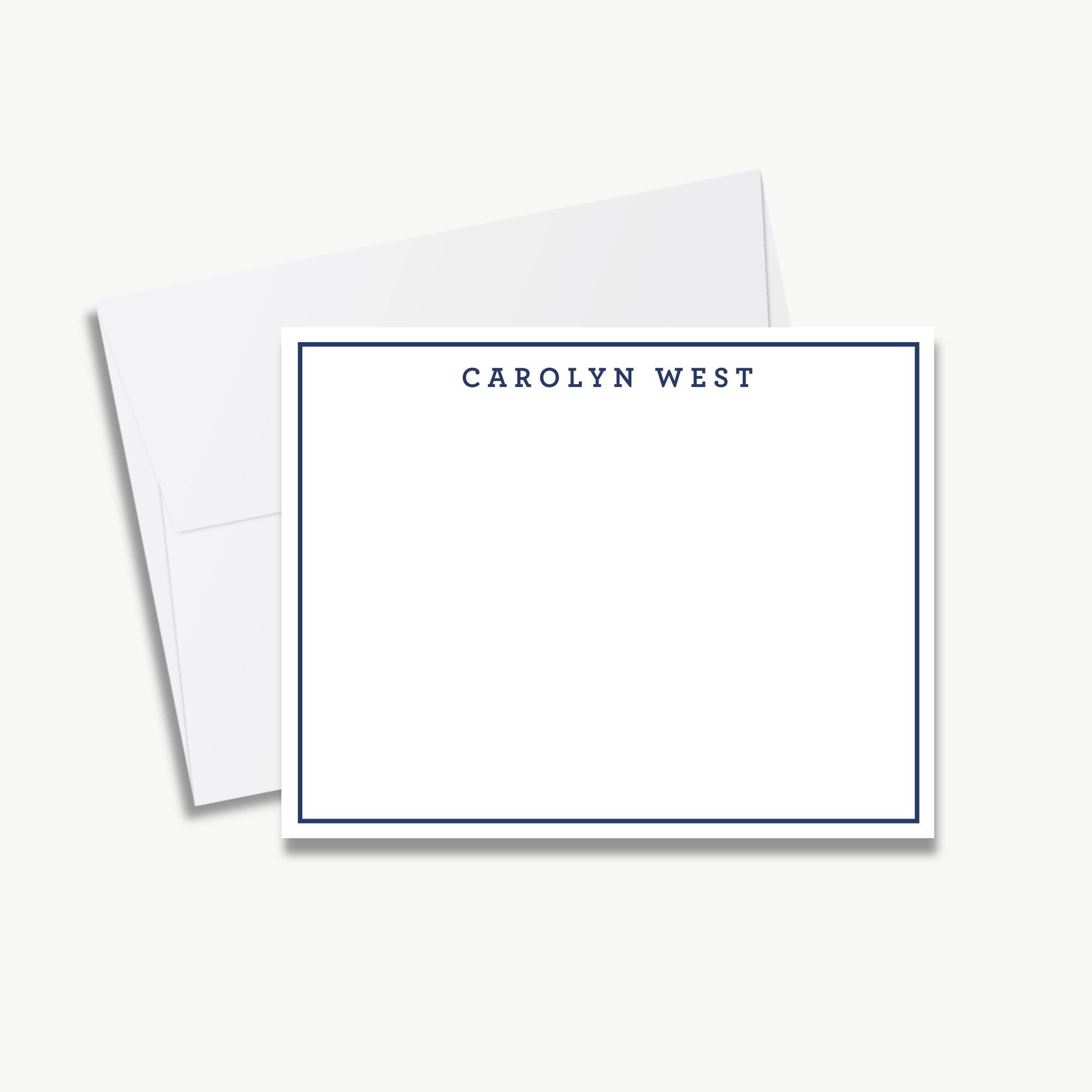 A blank white card with a blue border, placed on top of an envelope.