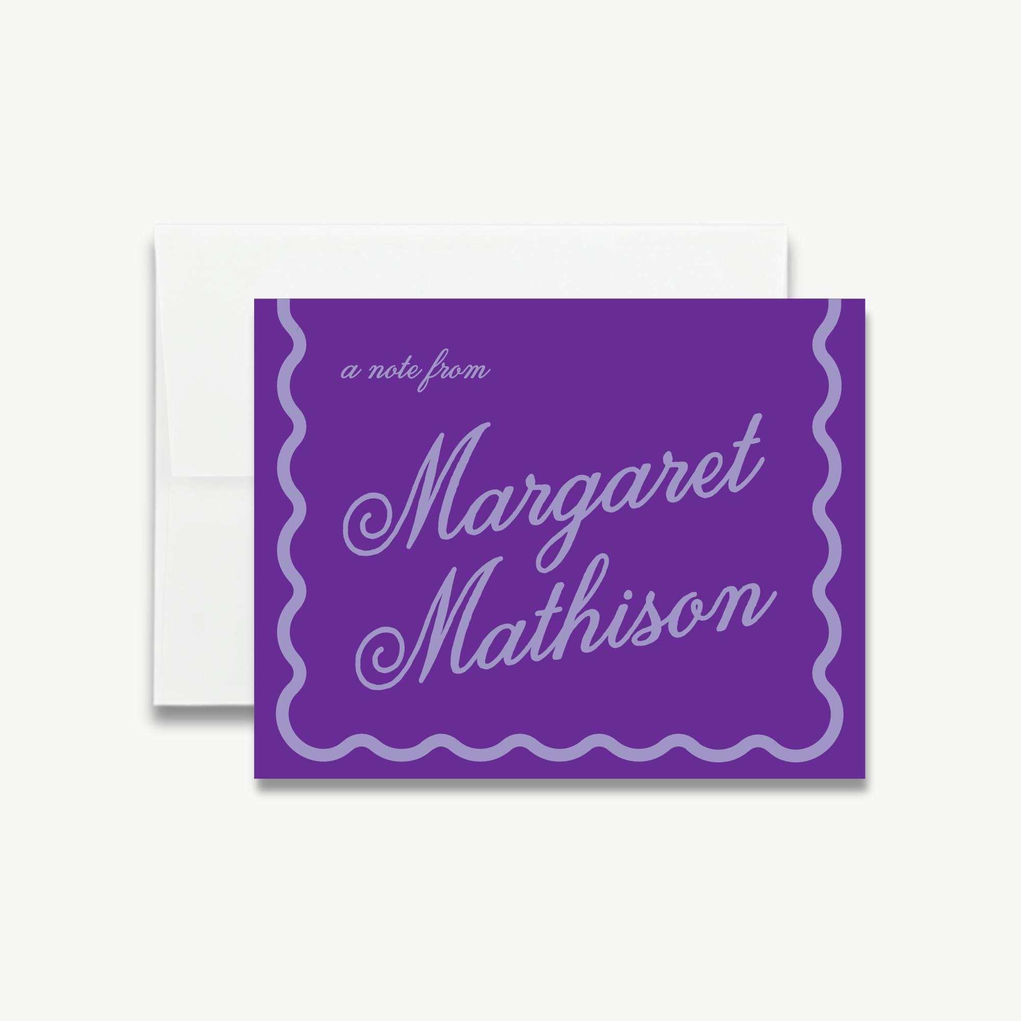 A note card with a purple background and a white scalloped edge, featuring the name "Margaret Mathison" written in cursive.
