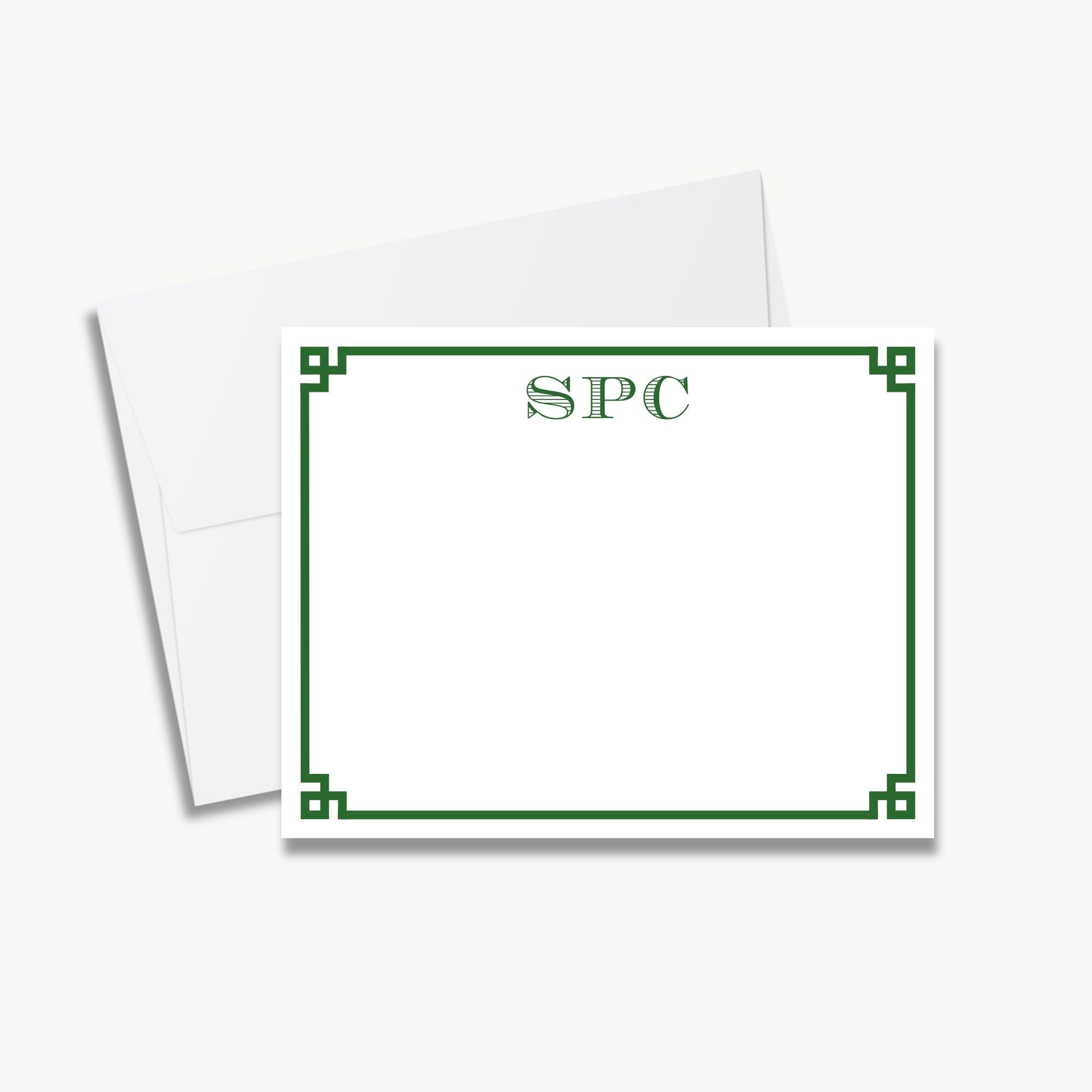 a white envelope with a green border and a blank card inside it.