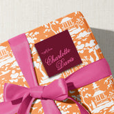 A gift wrapped in a paper with a bow and a tag that reads "a gift from Charlotte Davis".