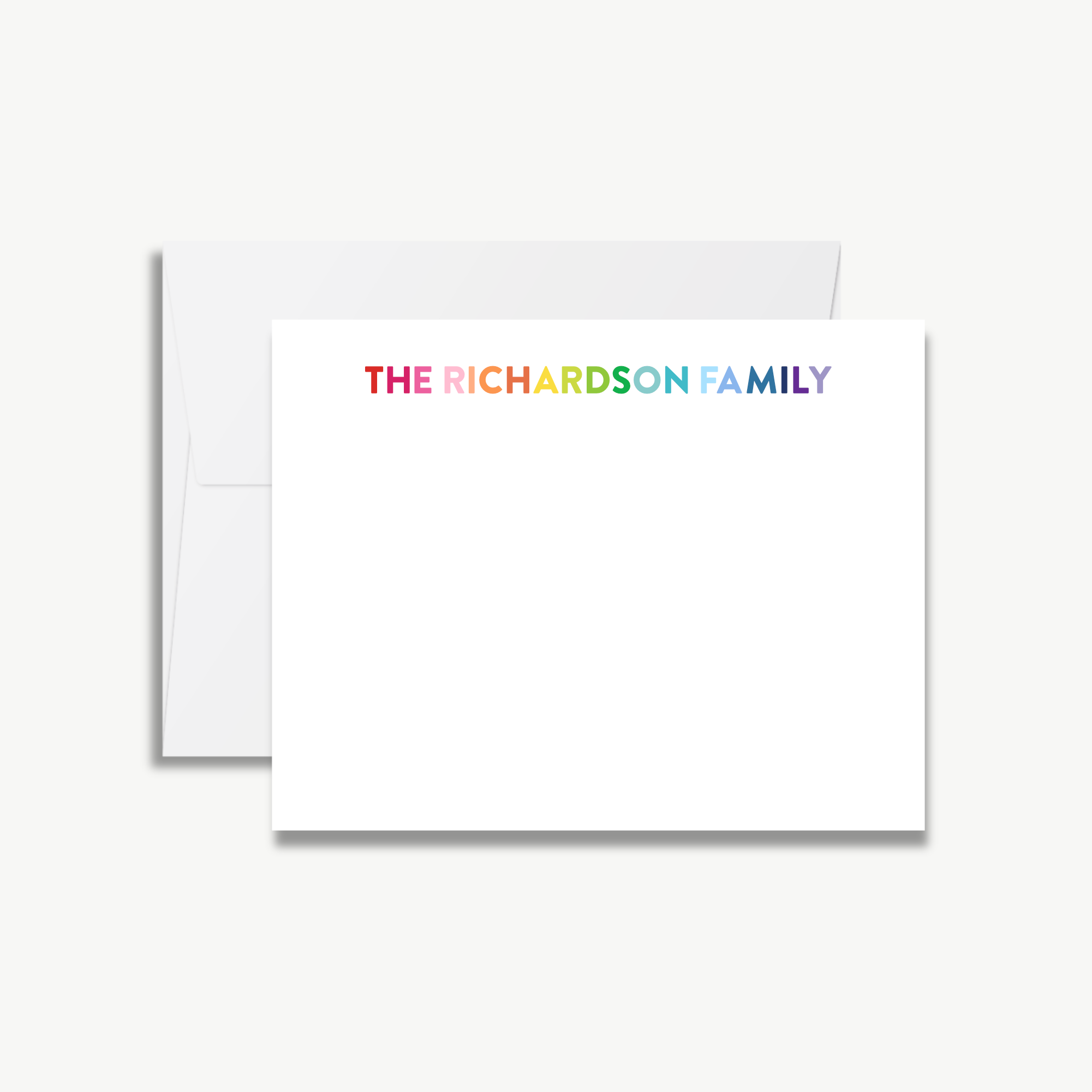 A white envelope with a blank card inside, featuring the text "THE RICHARDSON FAMILY" in a rainbow color scheme.