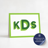 A greeting card with the text "KS" in large green letters, placed on a white background.