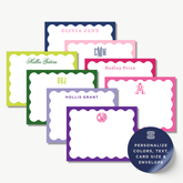 a collection of personalized name cards with scalloped edges, each featuring a unique name and monogram. The cards are arranged in a row, showcasing a variety of colors and sizes.
