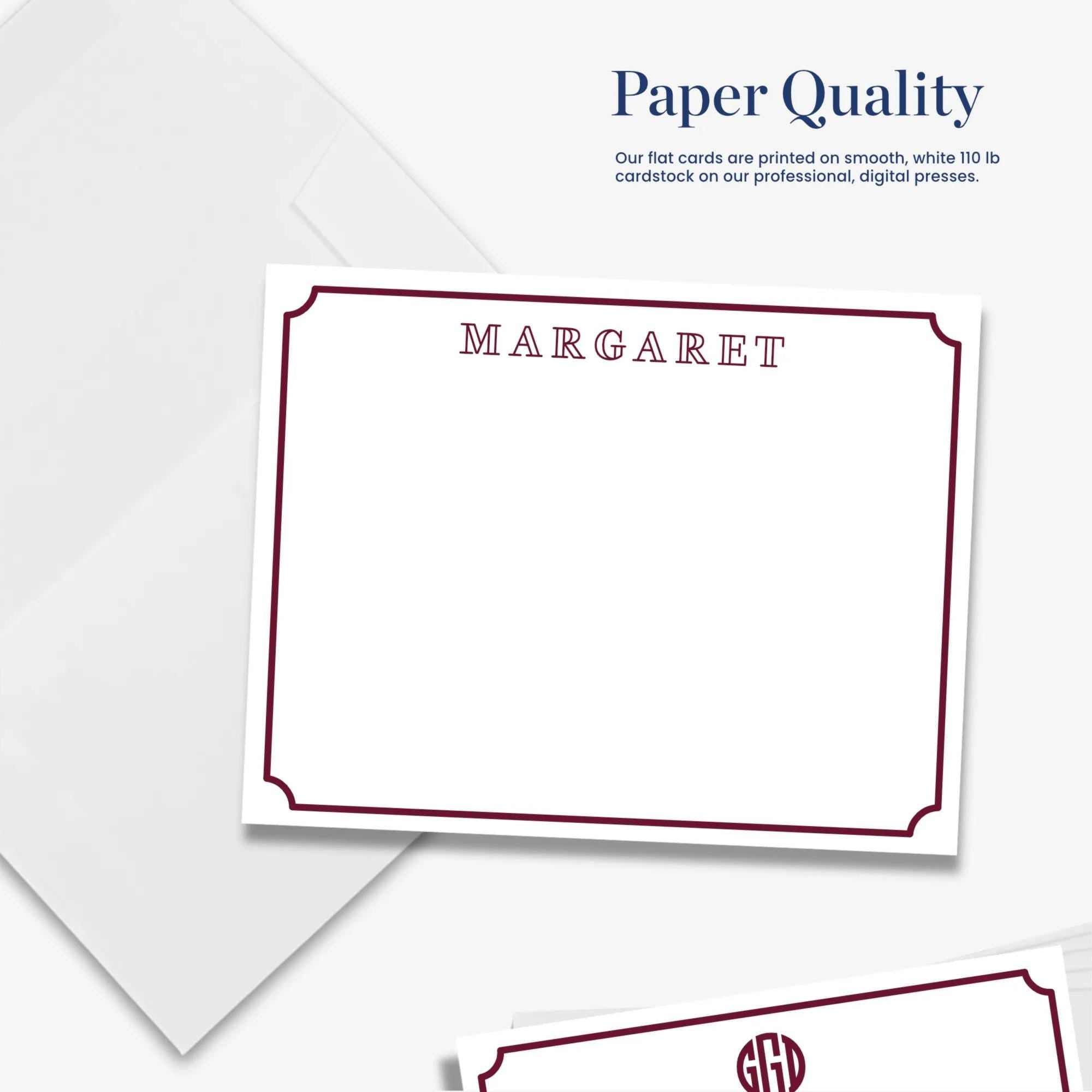 The image is a white card with a red border, featuring the name "MARGARET" printed on it. The card is placed on a white background, and there is a white envelope with a red border in the background.