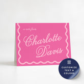 A pink greeting card with the name "Charlotte Davis" written on it, along with a wavy border design.