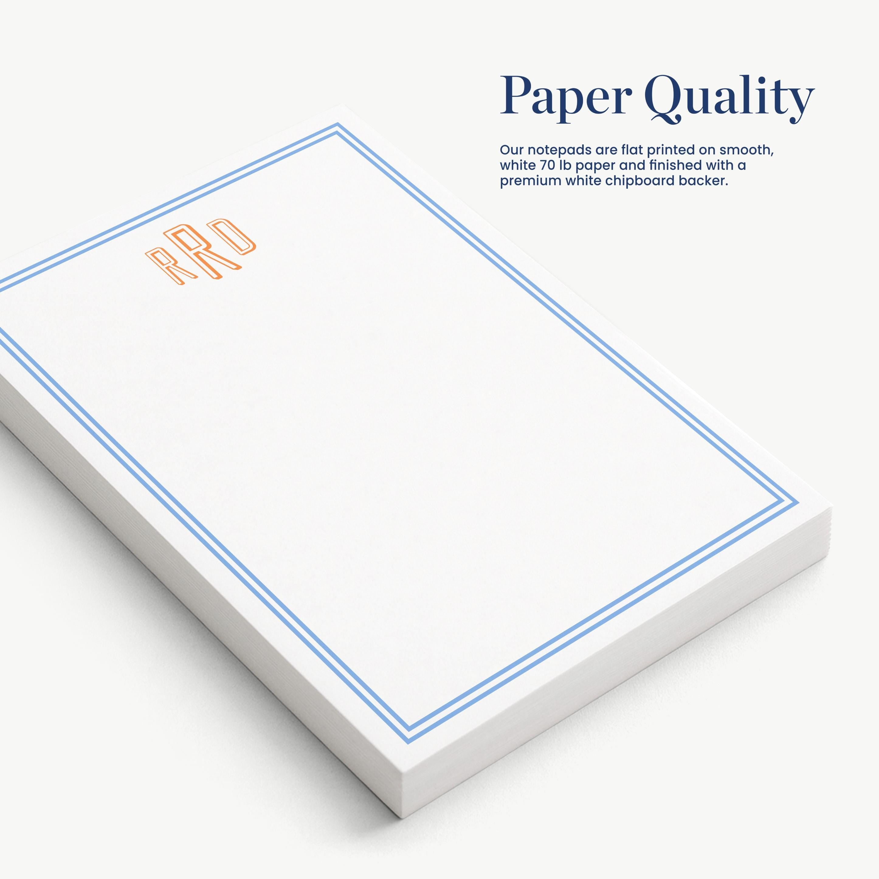 a set of white notepads with blue borders, arranged on a white surface.