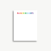 A white piece of paper with the name 'Parker Roberts' written on it in rainbow colors.