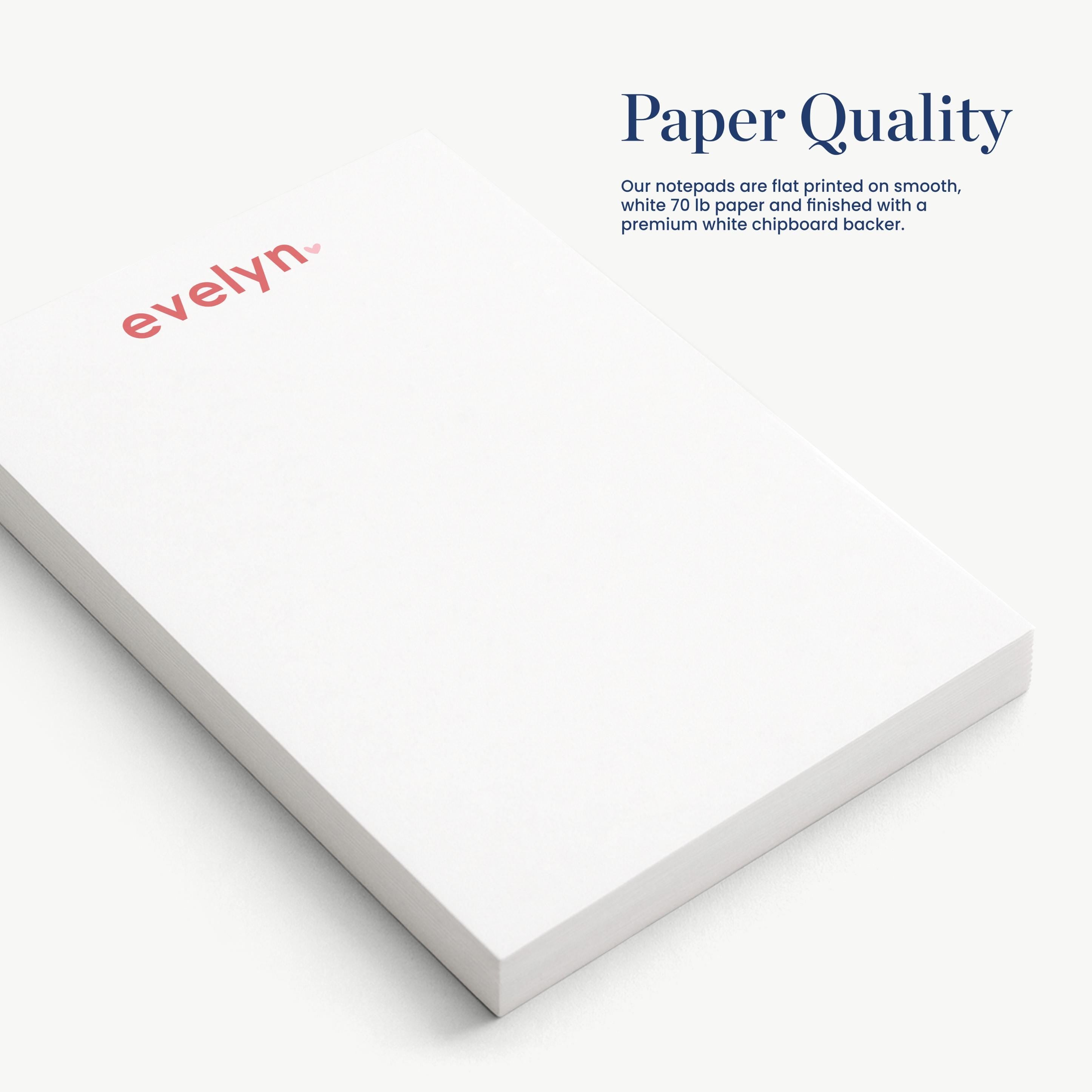a close-up view of a white notepad with the word "evelyn" printed on it.