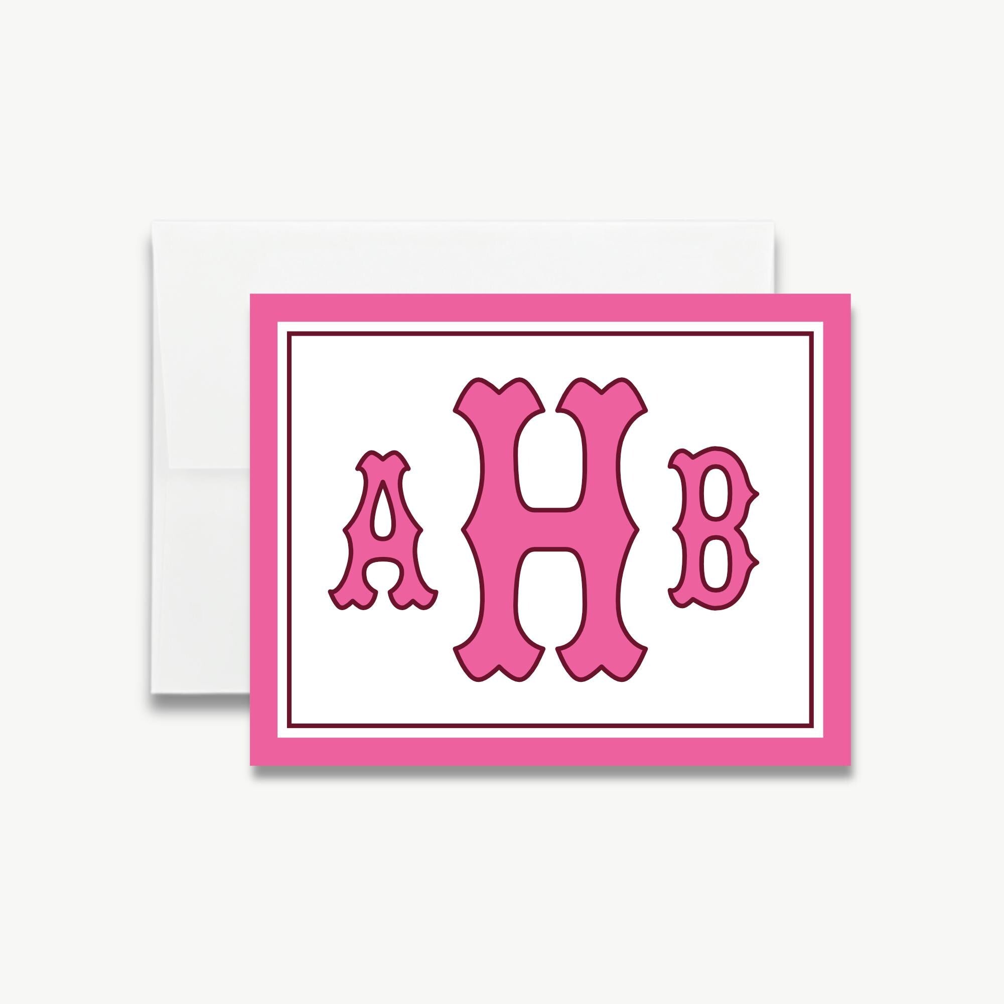 A pink and white greeting card with the initials "AHB" displayed prominently in the center.