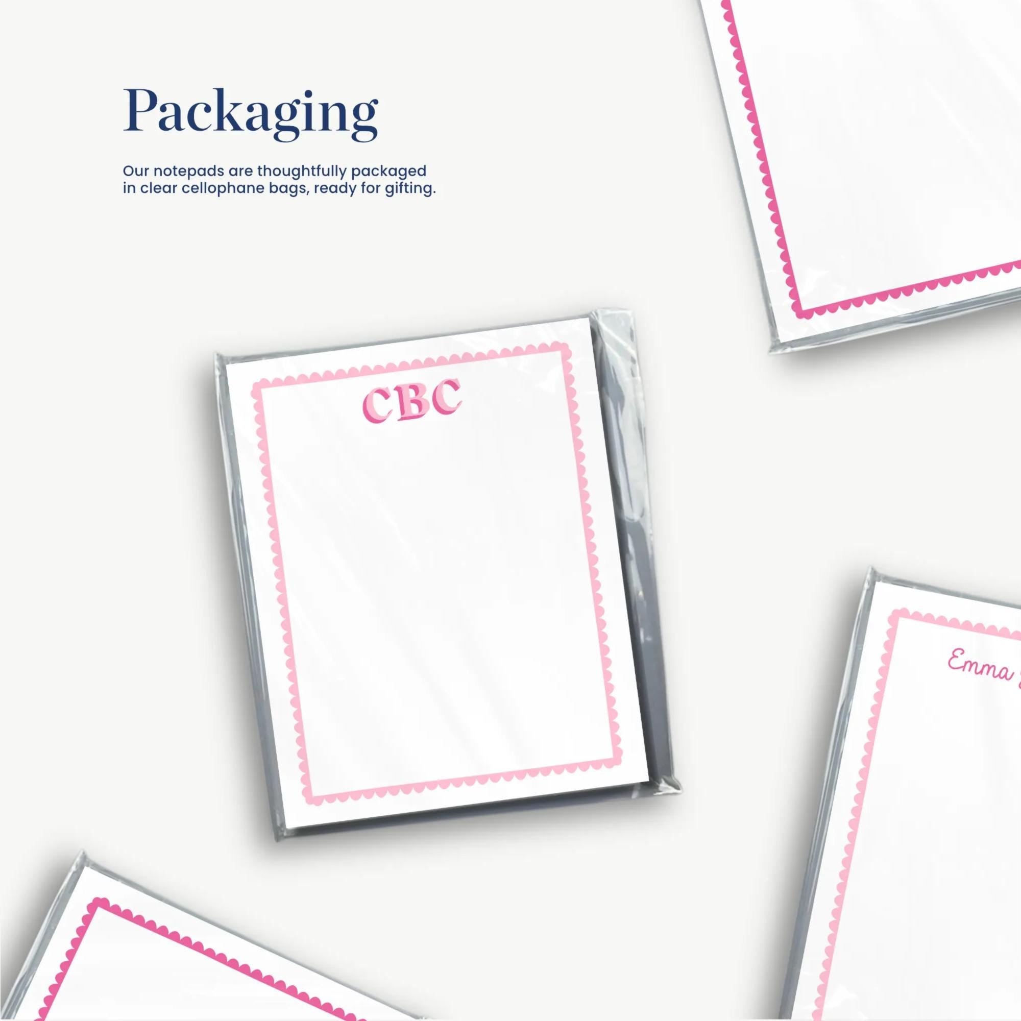 several blank cards or envelopes with pink borders, along with some text and logos. The text and logos are not described in detail, and the image does not contain any redundancy or vague descriptions.