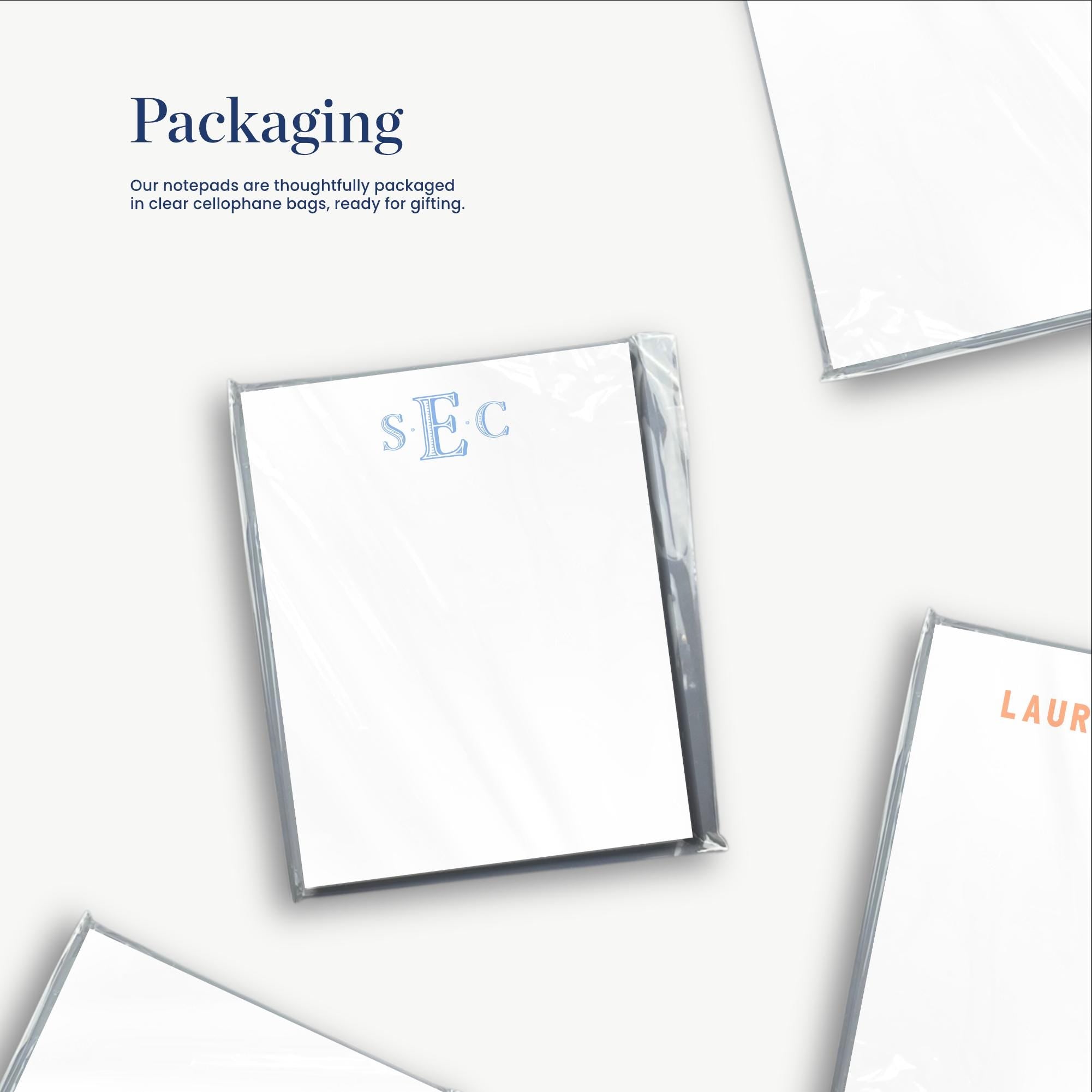 a close-up view of several white notepads or pads, each with a clear plastic sleeve or packaging. The text "Packaging" is visible, indicating that the notepads are thoughtfully packaged in clear cellophane bags, ready for gifting.
