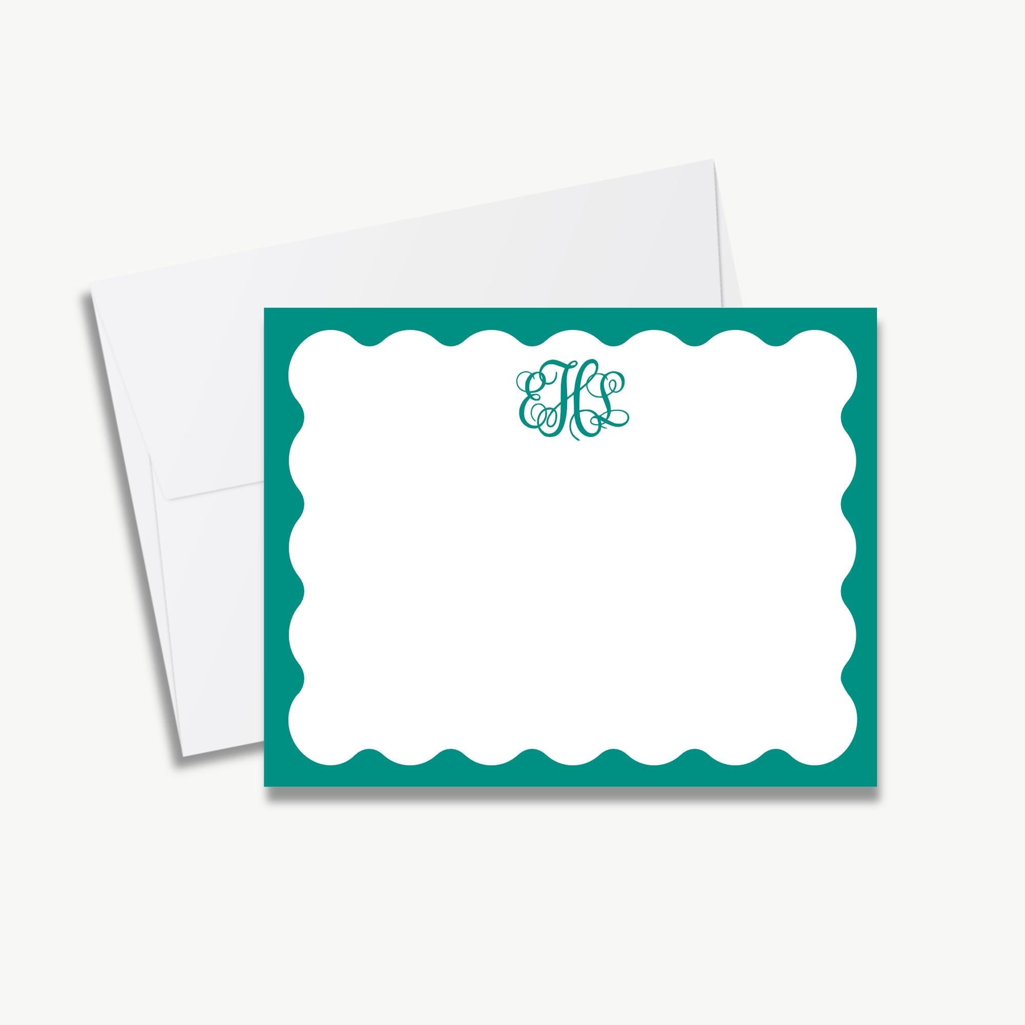 a white card with a teal border and a monogrammed logo in the center.