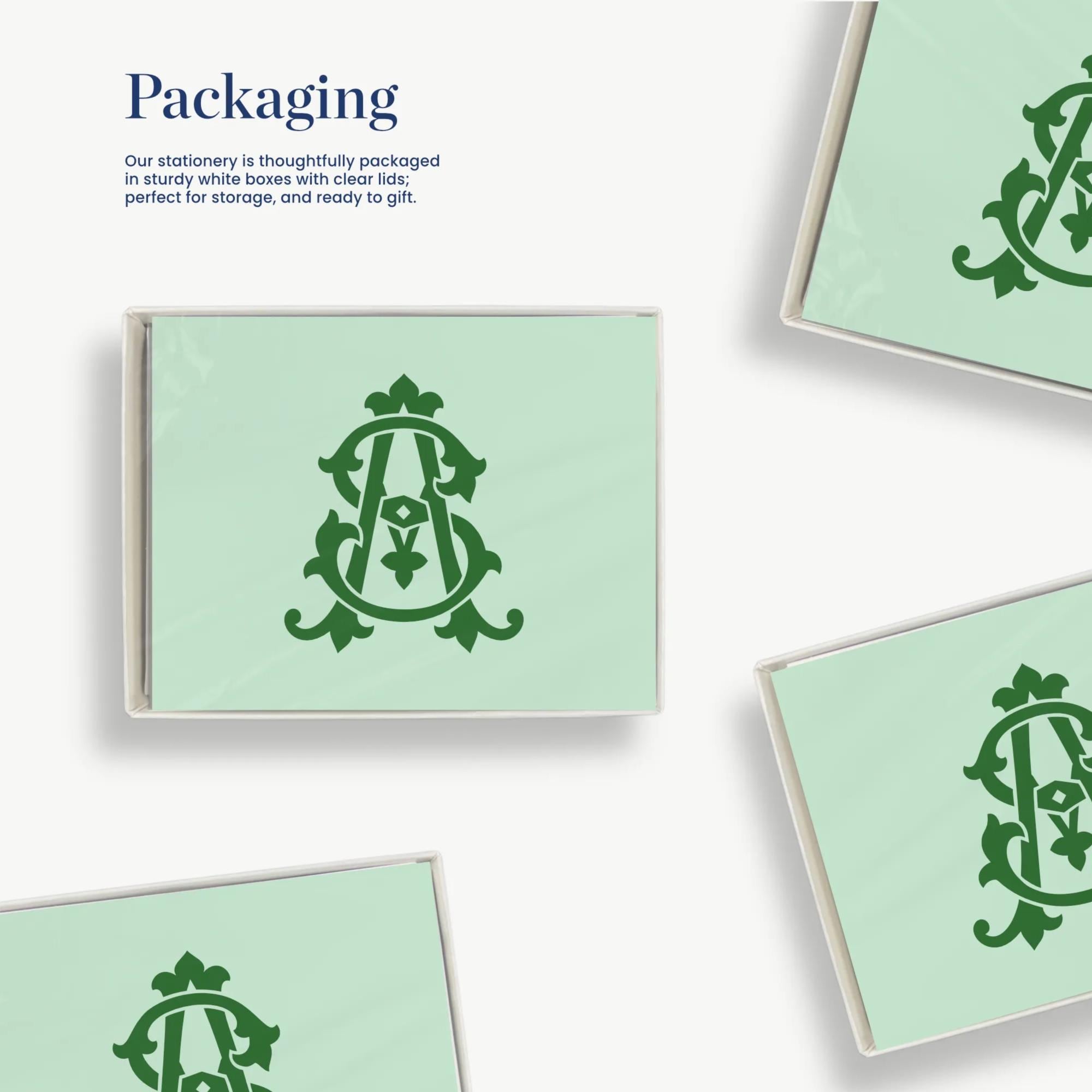 a collection of green square cards with a stylized monogram design on them.