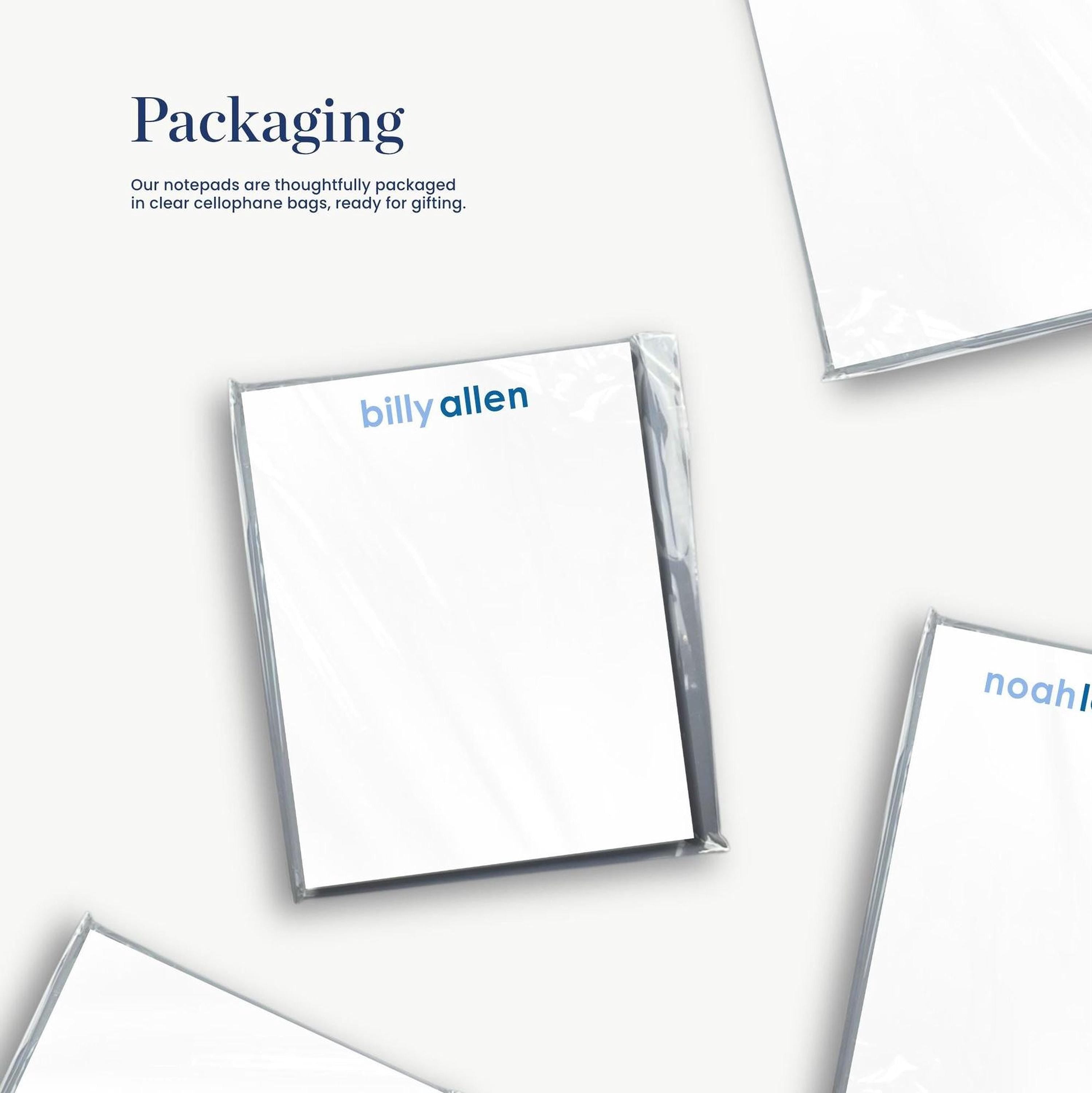 several white notepads with the name Billy Allen' printed on them, packaged in clear cellophane bags.