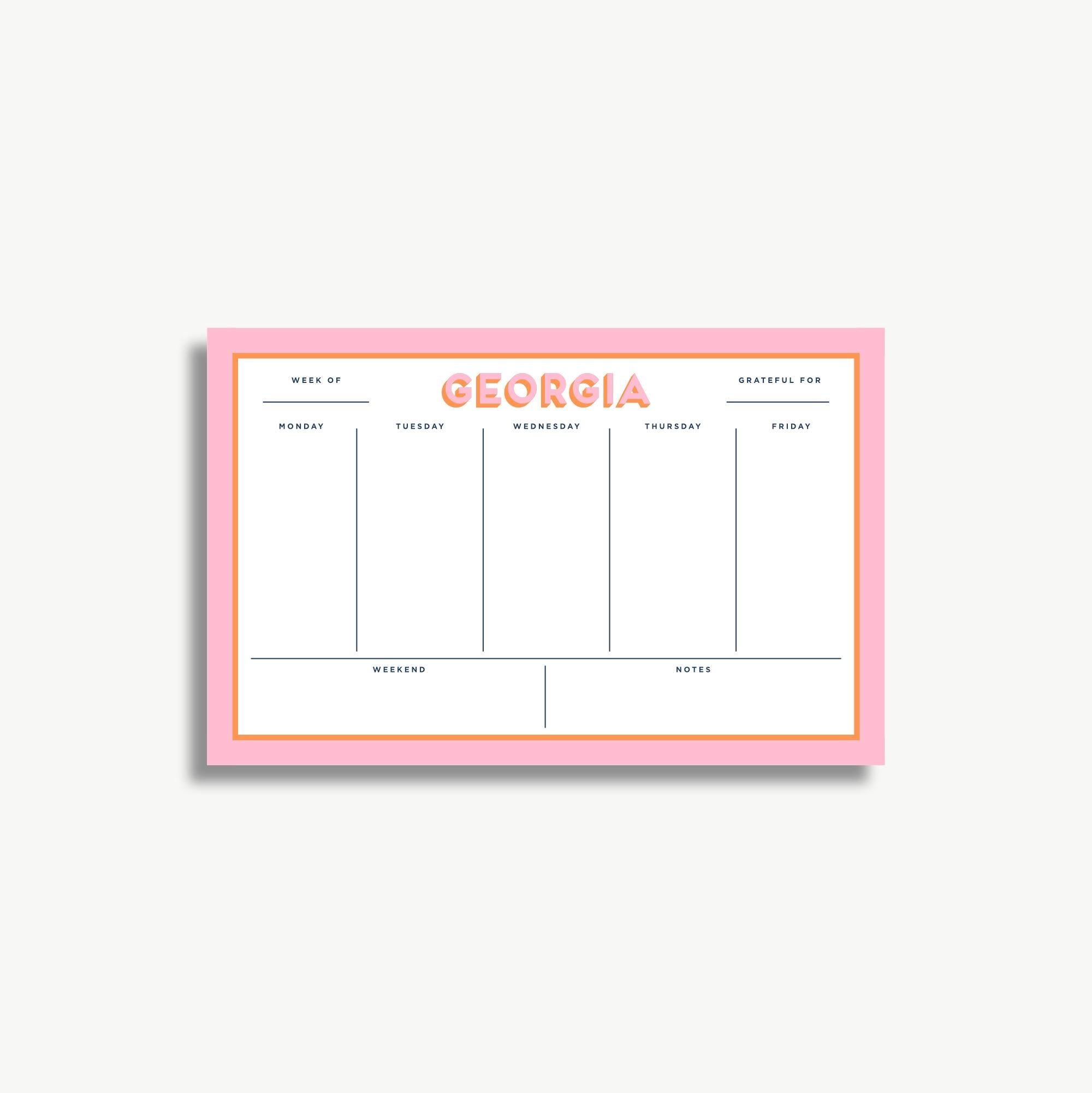 The image is a pink and white calendar or schedule organizer with the word "GEORGIA" prominently displayed. It appears to be a simple, functional design with a grid layout for organizing days and events.