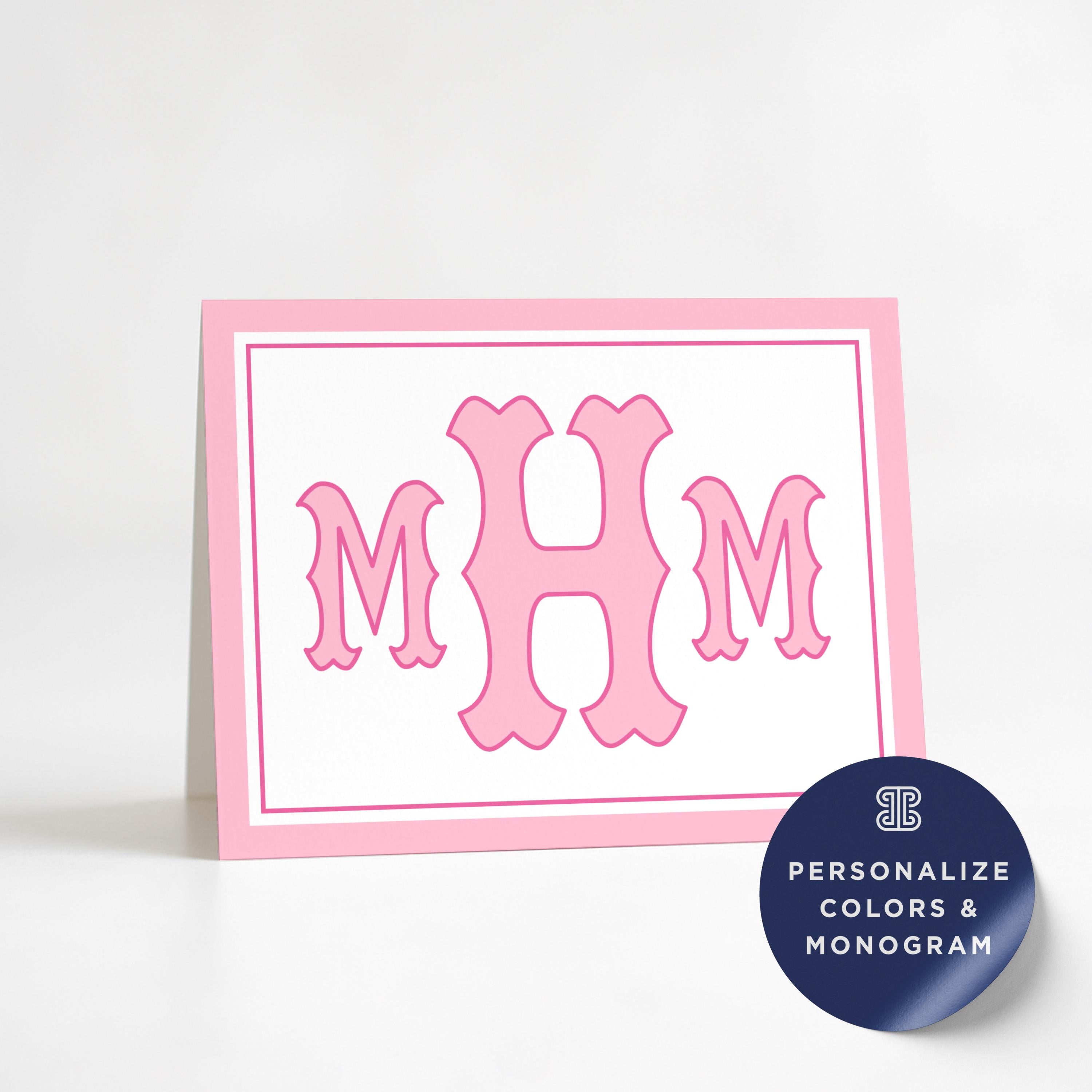 a pink greeting card with a large pink monogram of the initials 'M H M' on it.