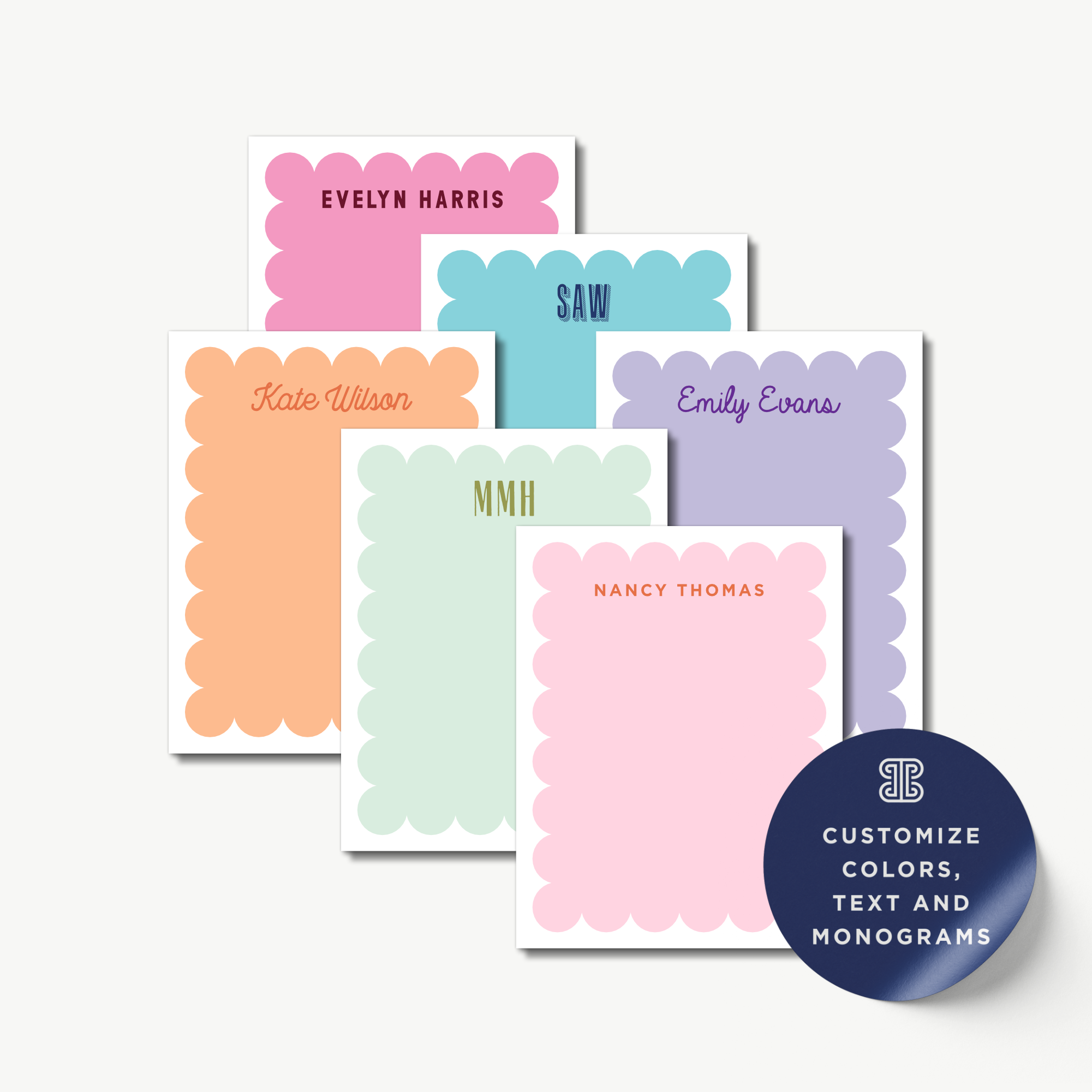 a collection of personalized name cards with scalloped edges in various pastel colors, including pink, orange, green, blue, and purple.