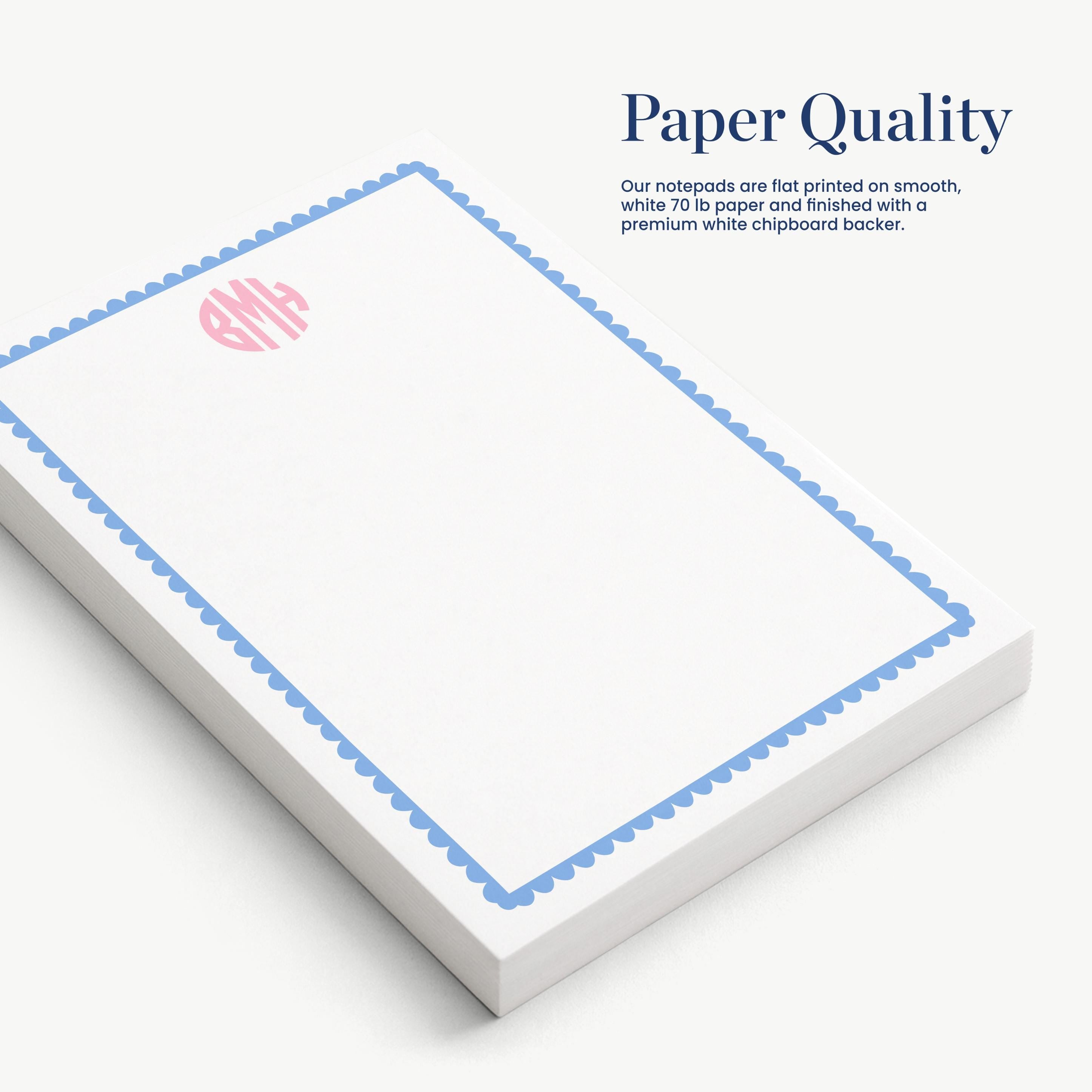 a set of white notepads with a blue border, arranged on a white surface.