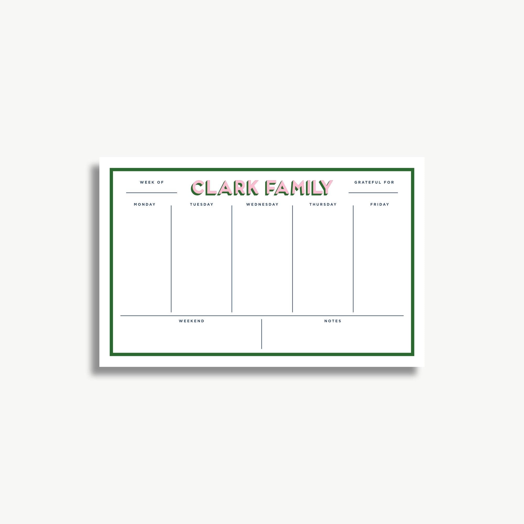A white and green weekly schedule planner with the name "CLARK FAMILY" printed on it.