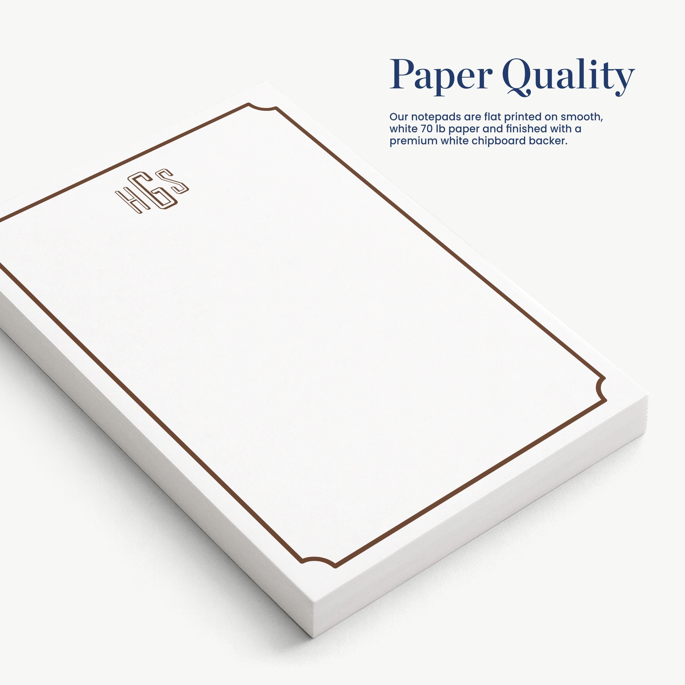 a white notepad with a brown border, placed on a white surface.