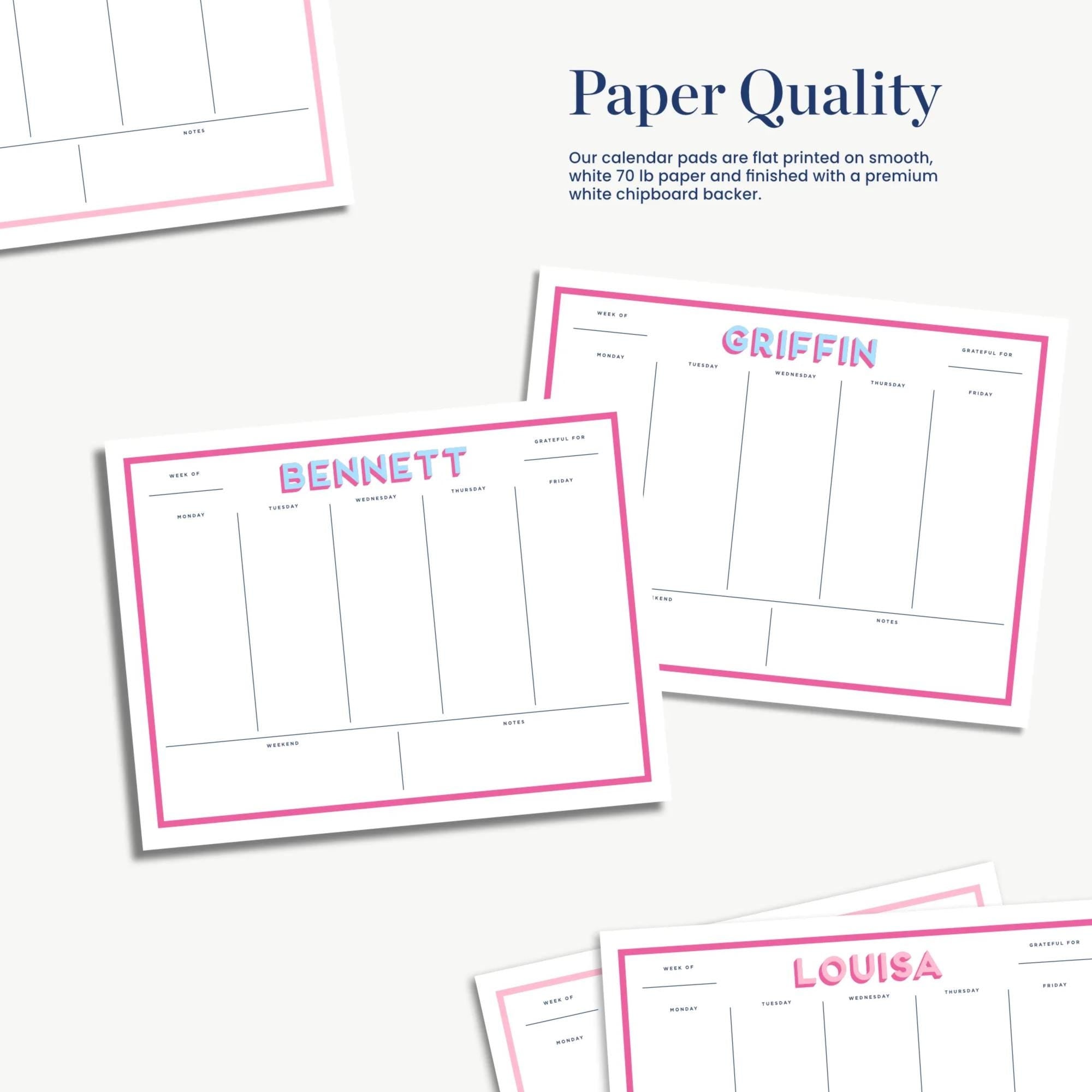 several pink and white paper quality cards with names printed on them, along with a section for a calendar.