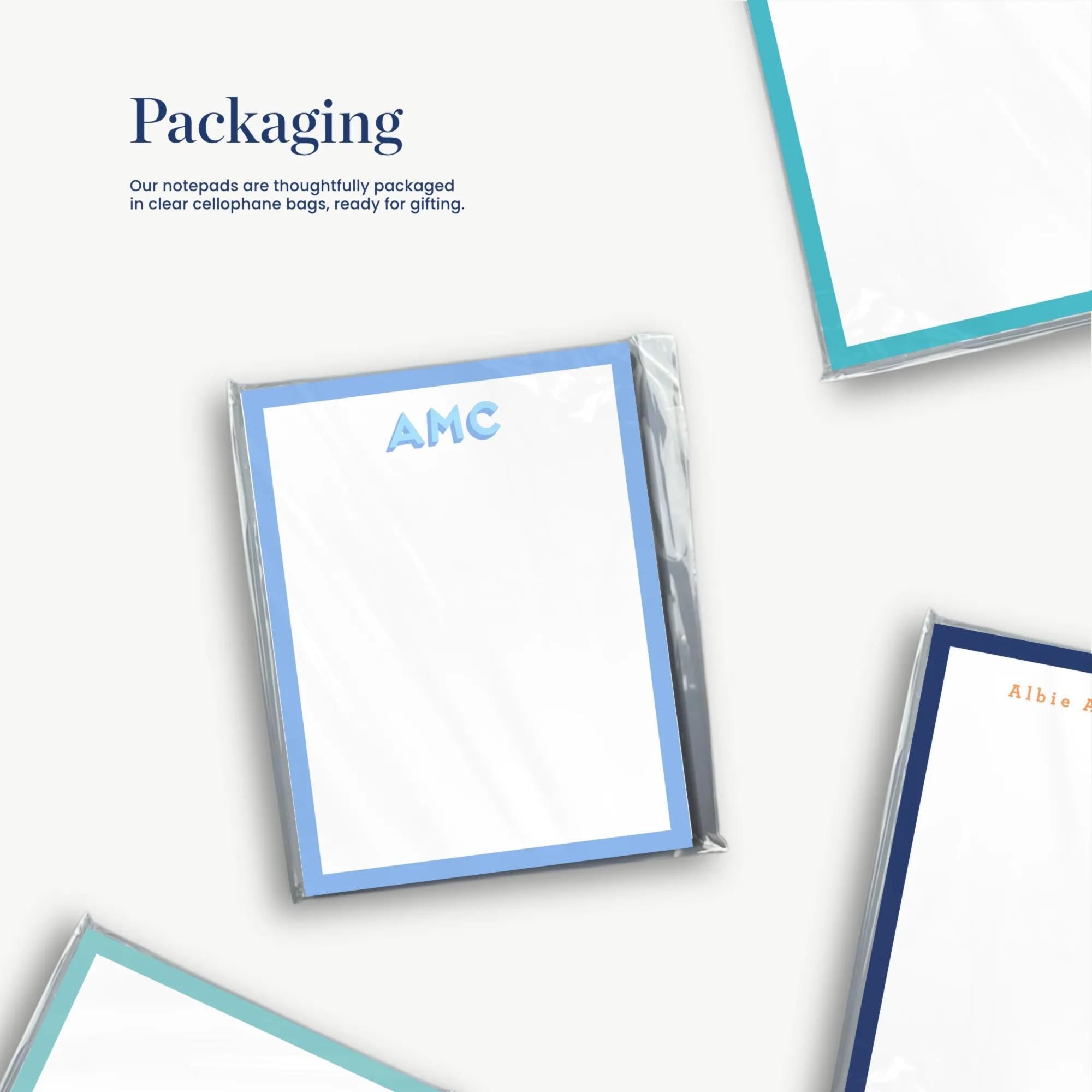 three different frames, each with a blank white background and a blue border. The text above the frames reads "Packaging" and "Our notepads are thoughtfully packaged in clear cellulose bags ready for gifting."
