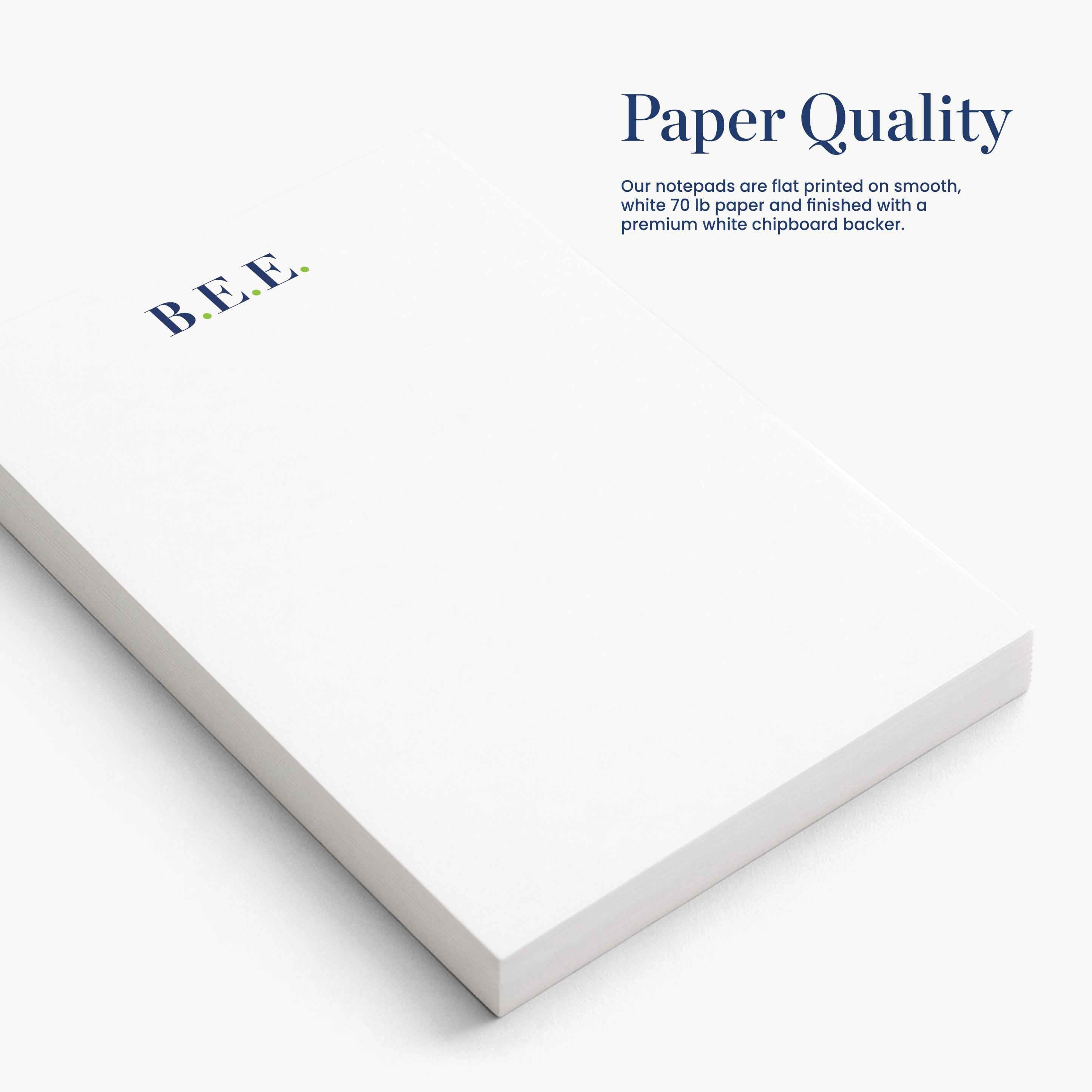 a close-up view of a white notepad with the text "Paper Quality" and "Our notepads are flat printed on smooth, white, 70g paper finished with a premium white chipboard backing."