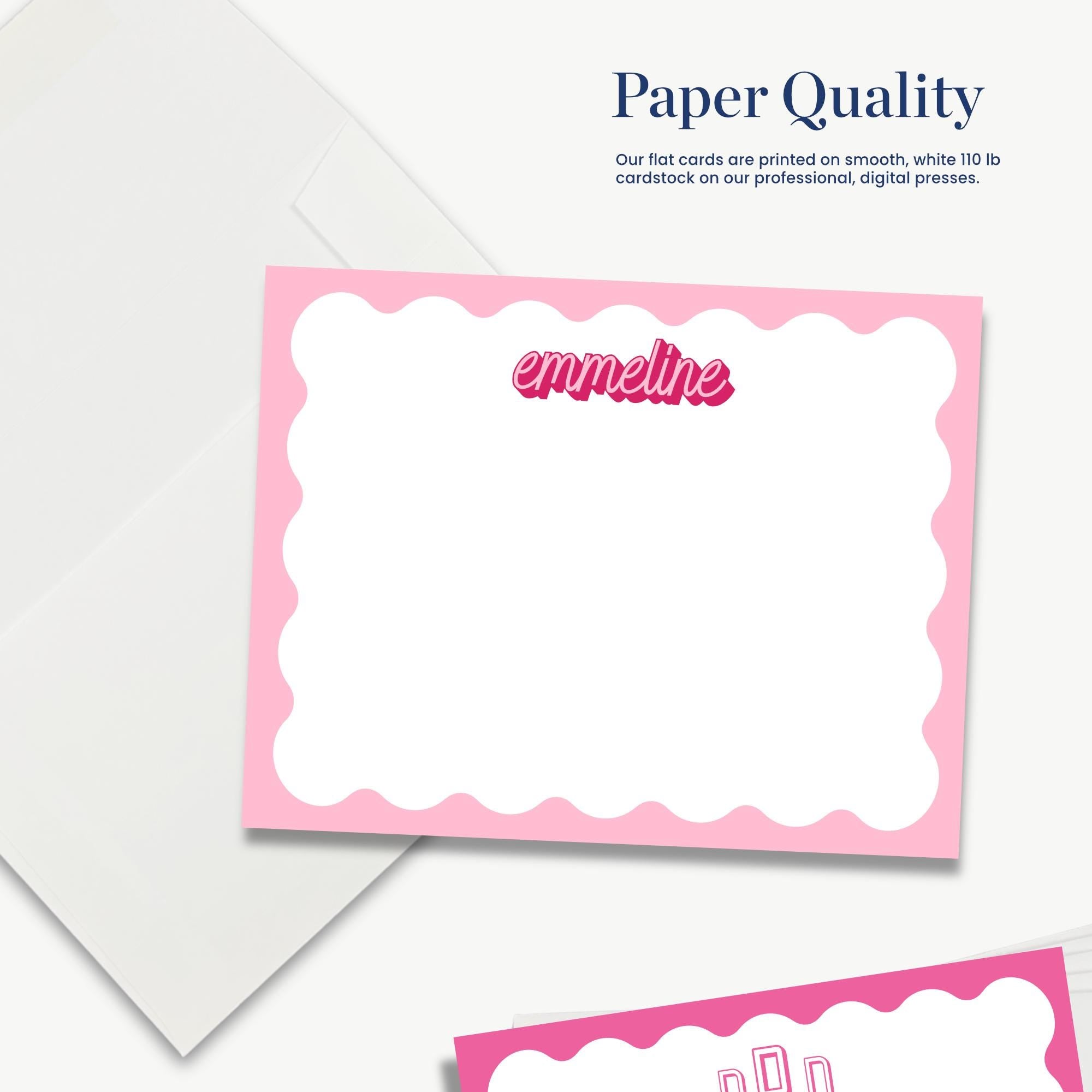 The image is a close-up of a blank card with a pink border, placed on a white background.