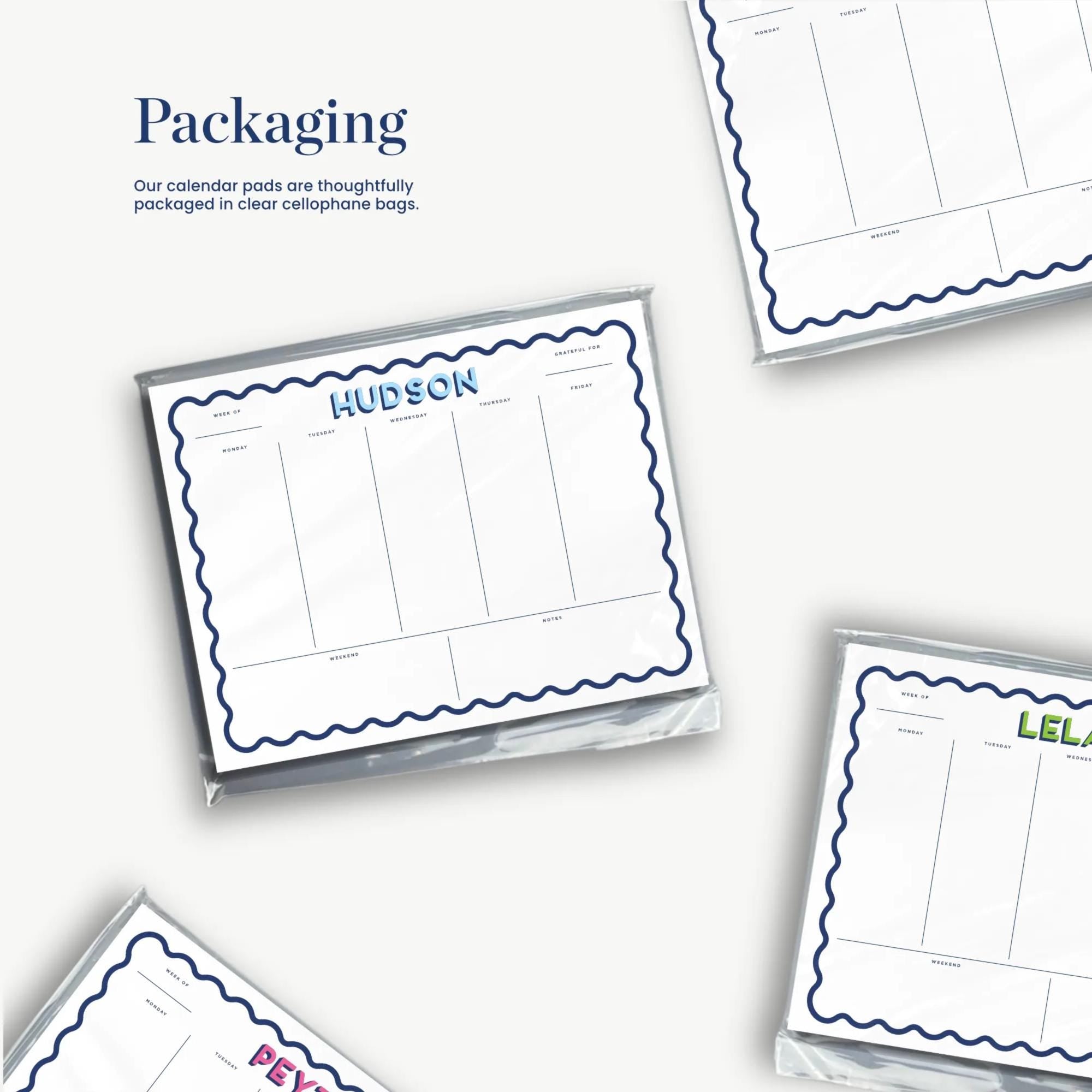 a collection of calendar pads with names and dates, arranged in a way that suggests they are thoughtfully packaged in clear cellulose bags.
