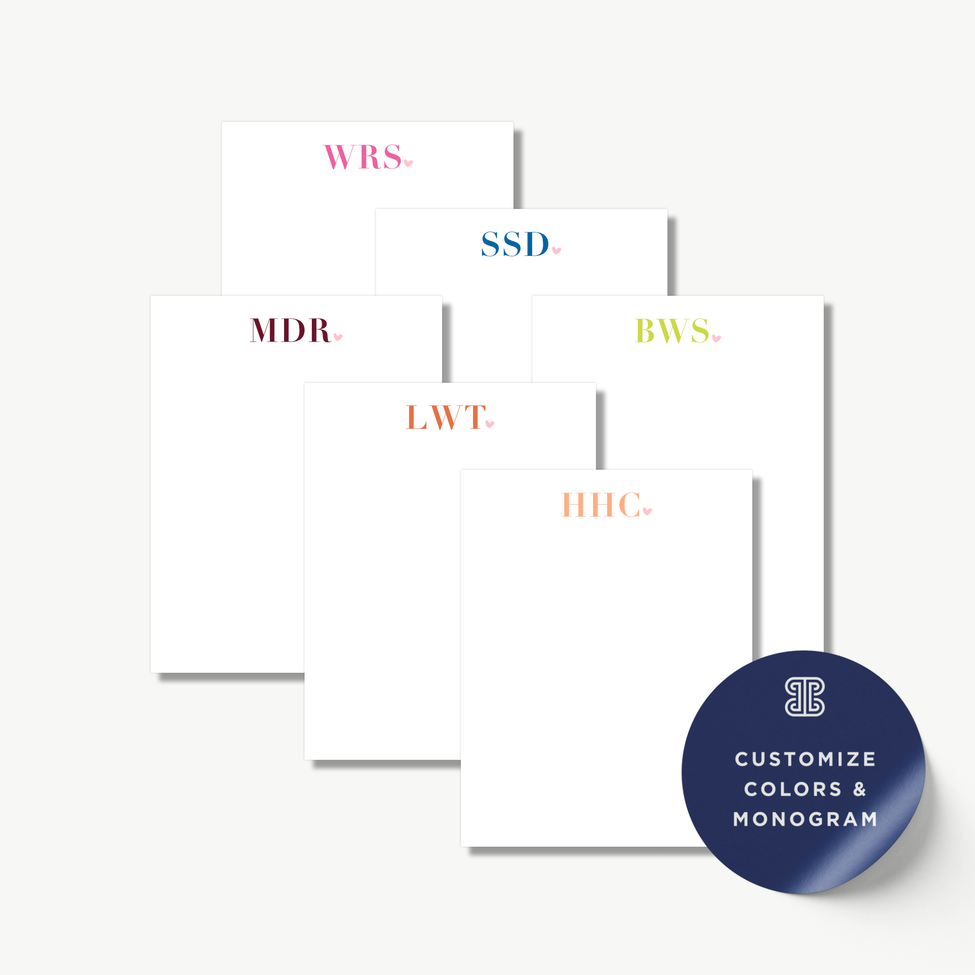 a collection of six blank notepads with personalized monogrammed initials on them, arranged in a grid-like pattern.